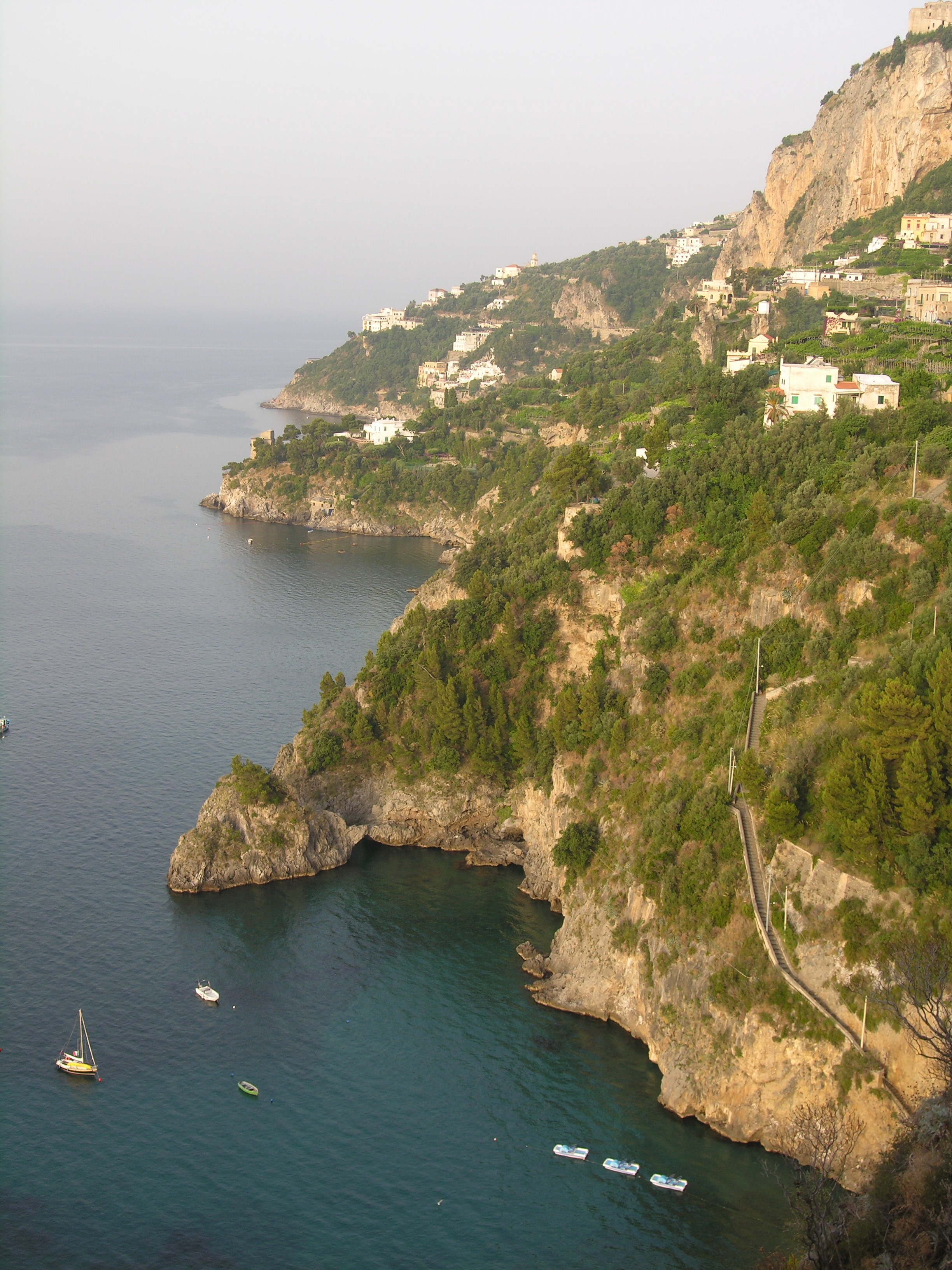 Sweeping panoramic view of the Amalfi Coast with terraced hillsides and blue Mediterranean waters