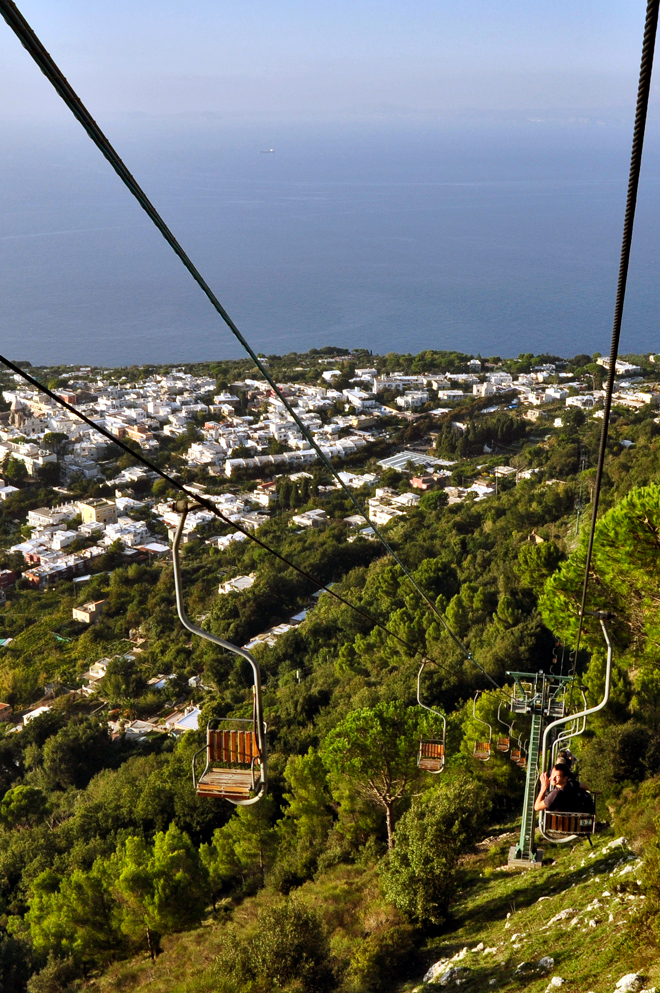 Monte Solaro chairlift ascending over Anacapri rooftops with sea view