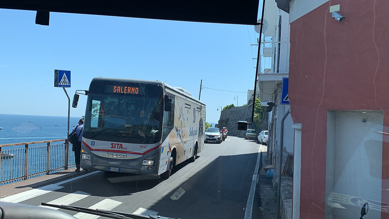 Curreri Viaggi bus at Naples Airport stop showing luggage compartment
