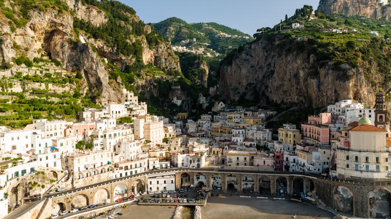 Picnic spread with local cheese, bread, and fruit overlooking Positano.