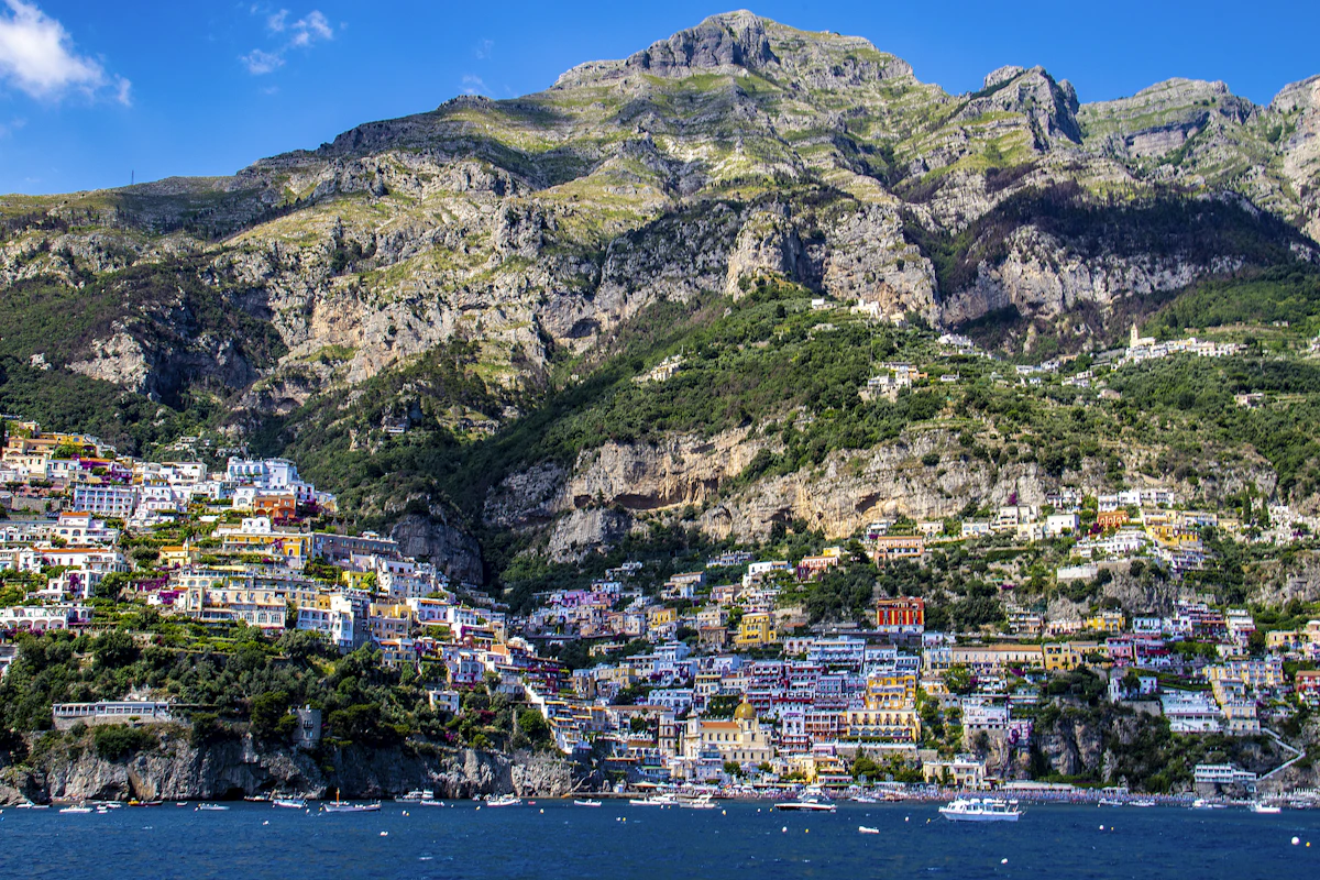 Sunset over Positano with warm light on the cliff face